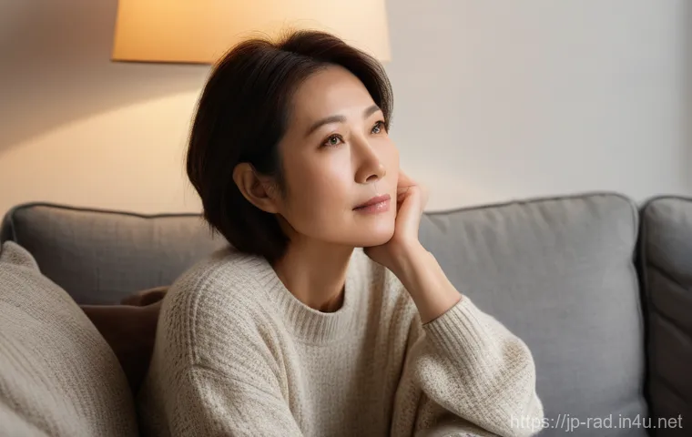 방사선 치료 장기 부작용 - A middle-aged Japanese woman, in her late 40s, sits quietly on a comfortable sofa in a softly lit, c...